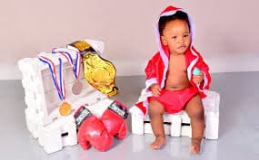 Future champion — baby boxer with title belt